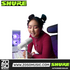 A young woman using a white Shure MV6 USB gaming microphone on a desktop stand in a vibrant, neon-lit gaming setup.