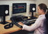 Zoso Music user operating a compact Yamaha DM3S 22-channel digital mixer in a home studio setup with monitors.