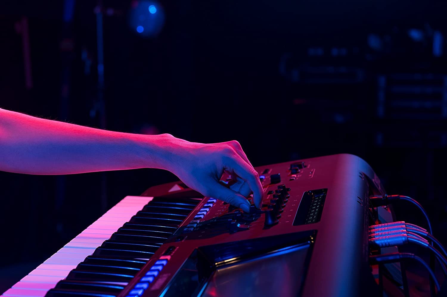 Zoso Music Yamaha Genos2 76-key arranger workstation being played by a musician in a dark, moody studio setting.
